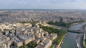 PARIS, FRANCE - MAY 30, 2023: Panorama aerial view of of Paris downtown along the Seine river. Drone view on river and buildings in City center. Paris aerial video with view of bridges.