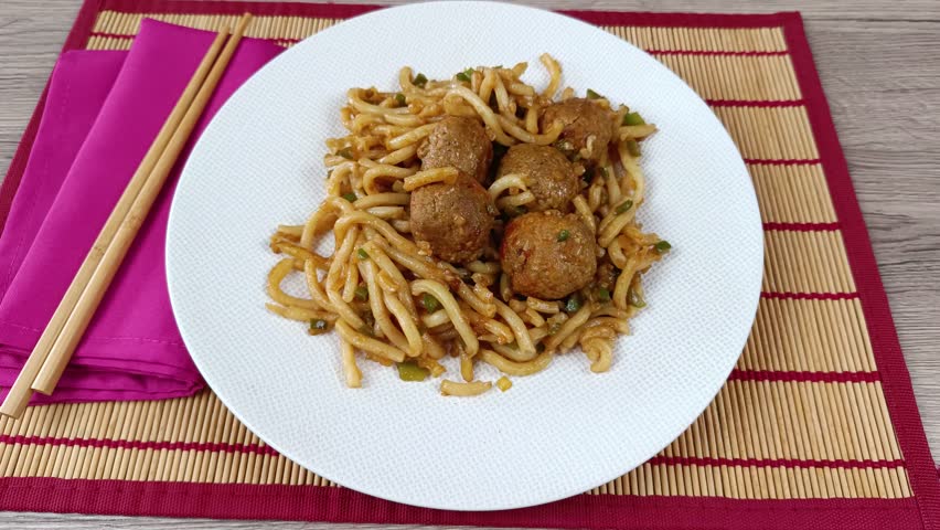 meatballs and noodles, close-up, on a plate