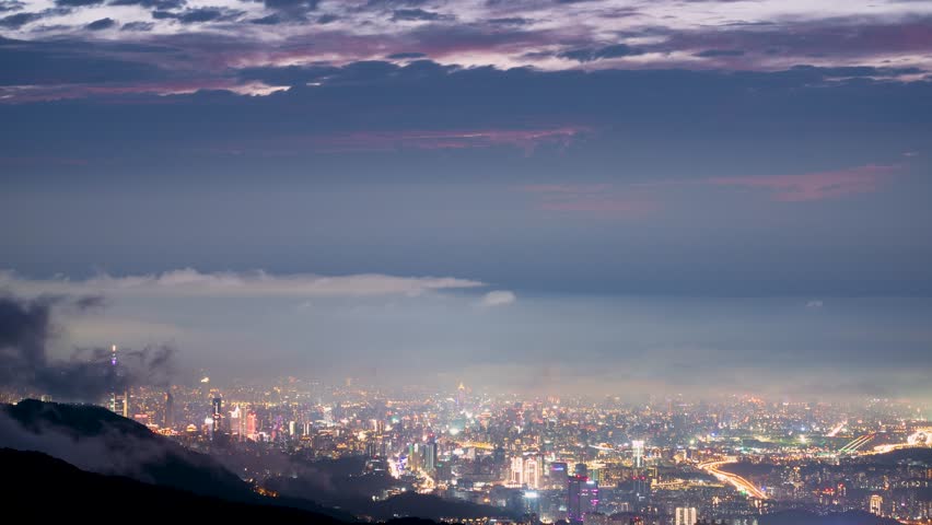 Rolling clouds and city lights enrich the night scene. Enjoy the night view of Taipei City from the mountain. Taiwan