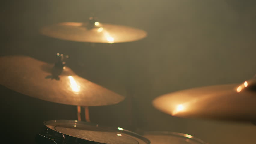Close-up drummer hands hit the drum cymbal with drumstick in a dark studio. Drummer plays the drums in the recording studio. Music band rehearsal Royalty-Free Stock Footage #3445402171