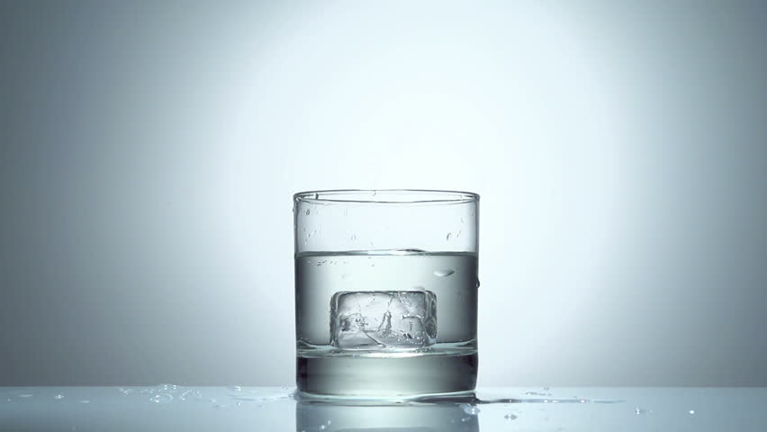 ice cube splash in glass of water on white, slow motion 250fps fullHD video
