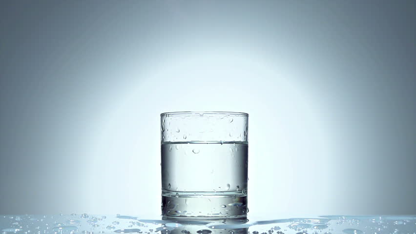 ice cube splash in glass of water on white, slow motion 250fps fullHD video