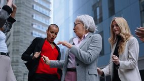 Group of excited business women diverse ages dancing outside the office center having fun enjoying and celebrating success at work. Female people entrepreneur and happy lifestyle concept. Slow motion  - Powered by Shutterstock - Get 15% off with code: PIKWIZARD15