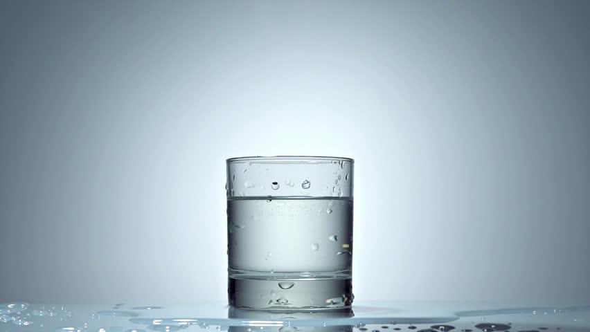 ice cube splash in glass of water on white, slow motion 250fps fullHD video