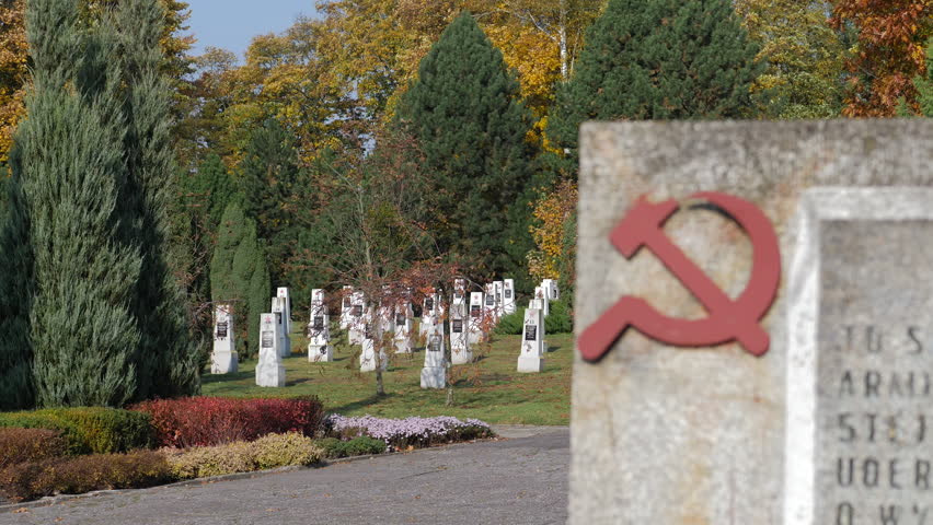 Soviet soldiers cemetery. Focus changing from gravestones to sickle and hammer Royalty-Free Stock Footage #3445467811