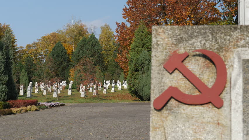 Soviet soldiers cemetery. Focus changing from gravestones to sickle and hammer Royalty-Free Stock Footage #3445471793