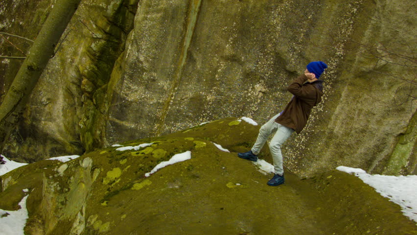 Young man dancing on a rock