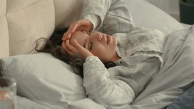 Caucasian brunette unhappy woman wake up on bed bedroom home inside holding head migraine headache massaging temples unhealthy discomfort illness girl painful suffering touching tired female disease - Powered by Shutterstock - Get 15% off with code: PIKWIZARD15