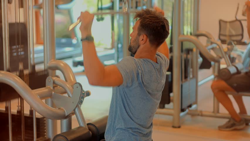 Man Weight Lifted Exercising In Gym Cable Pushdown. Multi-gym Workout. Chest Workout Push Down Biceps Curls. Indoor Bodybuilding Lifting Weight. Fitness Exercising In Sport Gym. Cable Triceps Pushdown Royalty-Free Stock Footage #3445593305