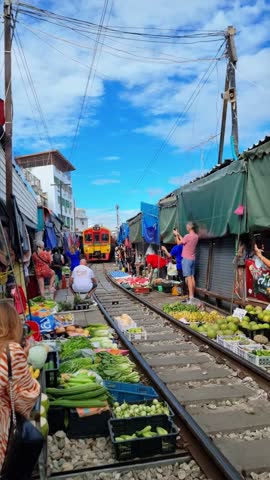 Maeklong Railway Market Thailand, Train on Tracks Moving Slow. Umbrella Fresh Market on the Railroad Track, Mae Klong Train Station, Bangkok, a famous railway market in Thailand Royalty-Free Stock Footage #3445627495
