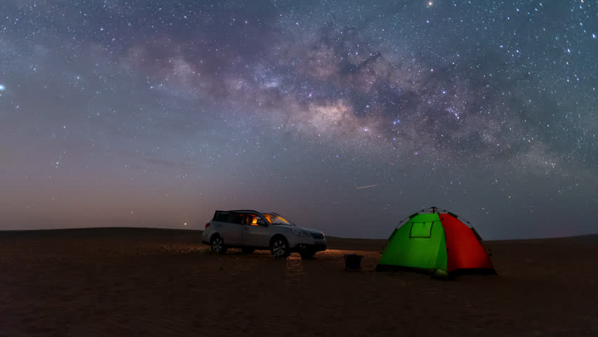 Time lapse of night Stars milky way motion across night sky during off road camping in desert.