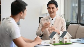 Salesman Hands On House Model , Small Toy House Small Mortgage Property insurance and concepts real estate
