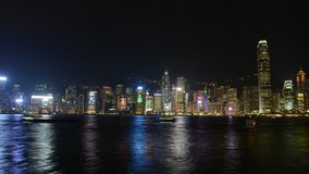 Timelapse HD video of Hong Kong harbour at night with city skyline of crowded buildings