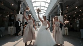 Joyful Bride and Bridesmaids Celebrating, Bride with bridesmaids dancing under chic lights in a luxury venue. - Powered by Shutterstock - Get 15% off with code: PIKWIZARD15