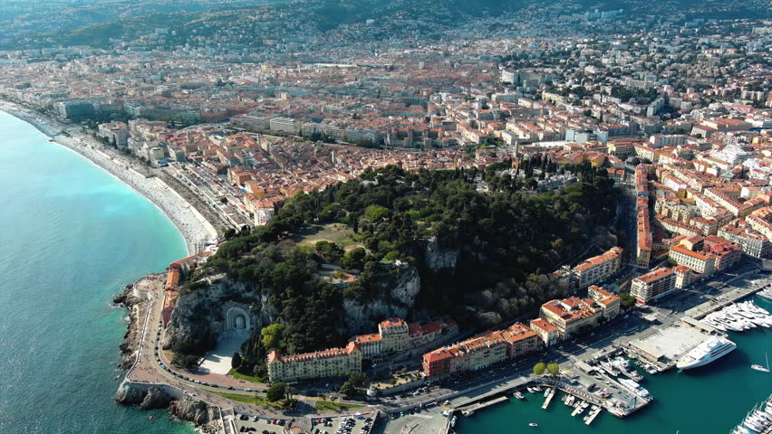 Panoramic aerial view of Nice, France. Beautiful hill ft. scenery landscape of harbor, port in Cote d'Azur. Luxury leading resort city of French riviera seen from above with Mediterranean Sea in 4K Royalty-Free Stock Footage #3445841959