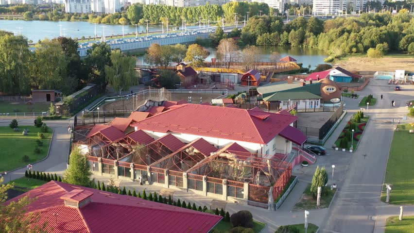 Minsk, Belarus - 30.10.2023: Minsk City Zoo from a height. Zoo buildings: cages, enclosures, animal cages, water cages for birds and animals. Zoo with a pond in Europe. Aerial view of the zoo.