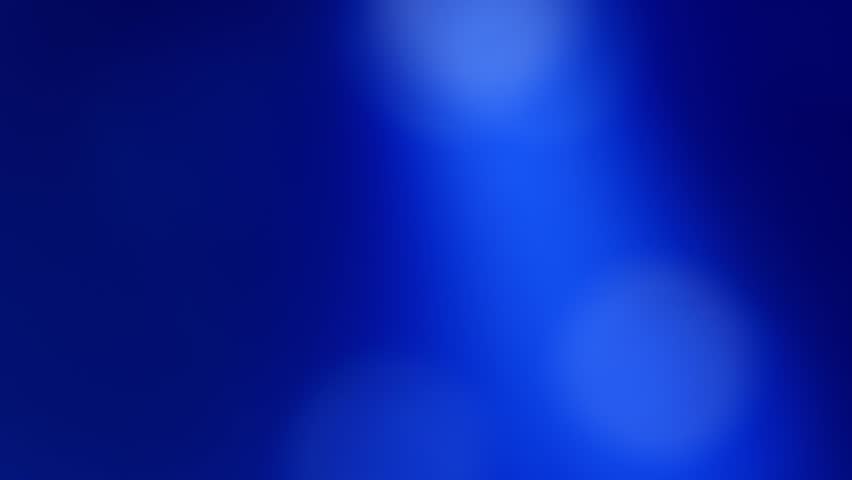 Abstract blurred background with colors in shades of blue, with moving lights flashing like those of a music concert. Real time video.