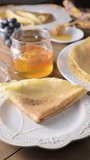 thin Russian pancakes adorned with fresh berries in this mouthwatering culinary showcase. Vertical video for social networks. cooking video. High quality footage