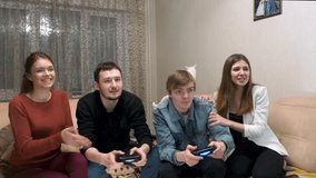 Two couples play game console.