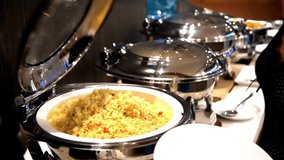 4K Ultra HD Video: Hotel Guest Scooping Fried Rice from Breakfast Tray at Food Bar