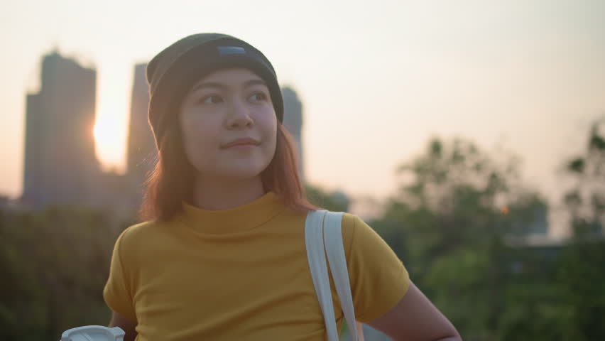 Go green Gen Z woman asia young people looking away in city life nature tree public park reuse cup eco tote bag save the earth world care reduce issues asian future hope net zero waste the way forward Royalty-Free Stock Footage #3446192707