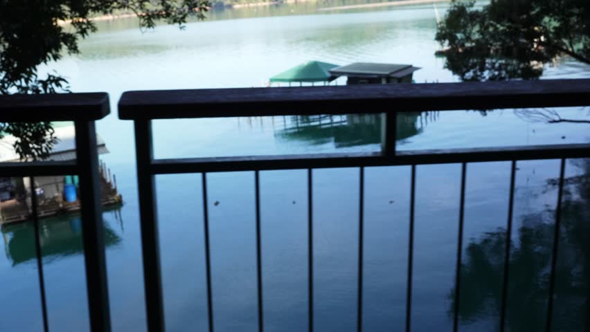 Serene Lake View with Floating Houses from Wooden Balcony