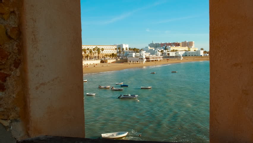 Revealing Playa La Caleta in Cadiz, Andalucia, Spain, picturesque beach nestled between historic fortresses, a favorite among tourists