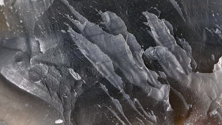 Natural uncut Agate (translucent variety of microcrystalline quartz  chalcedony) sample rotating slowly against a black background.