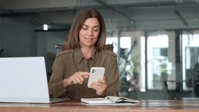 Smiling mature business woman executive using mobile phone working in office. Happy middle aged businesswoman holding smartphone, professional female executive looking at cellphone at workplace. - Powered by Shutterstock - Get 15% off with code: PIKWIZARD15