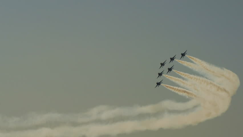 Panning Shot Of Fleet Of Aerobatic Planes Flying In Clouds - Huntington Beach, California