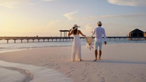A happy family in white summer clothing is having fun on a tropical beach during sunset time - Powered by Shutterstock - Get 15% off with code: PIKWIZARD15