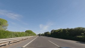 First person view, FPV, from dashcam of car driving in the beautiful Spanish countryside towards Seville, Andalusia, Spain, Europe. Road trip video in POV, with bright, sunny, blue sky - Powered by Shutterstock - Get 15% off with code: PIKWIZARD15