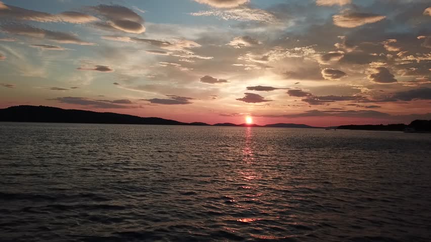 Aerial video over the Adriatic Sea at sunset in the Sibenik region in Croatia