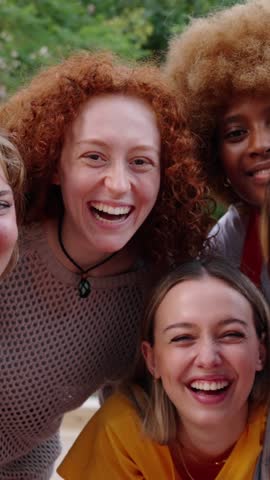 Vertical Group of only girls young cheerful multiracial friends looking at camera hugging happy in community. Diverse females looking camera. Empowered women students Royalty-Free Stock Footage #3446703787