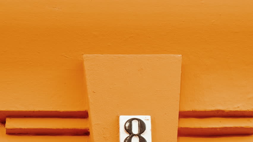 Number 8 (eight) affixed to the exterior of a building, with an elegant, vintage and traditional appearance
 Royalty-Free Stock Footage #3446723973