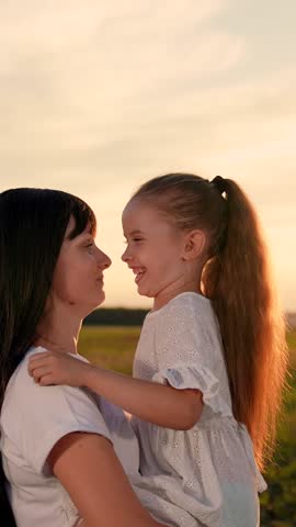 Carefree smiling mother and little daughter having fun together outdoors on sunny day. Mother hugs her child in park sunset. Happy family playing outdoor. Parent child having fun together summer sun Royalty-Free Stock Footage #3446727653