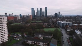 Establishing Aerial View Shot of Manchester UK, City Skyline England United Kingdom, day, patchy clouds, overcast