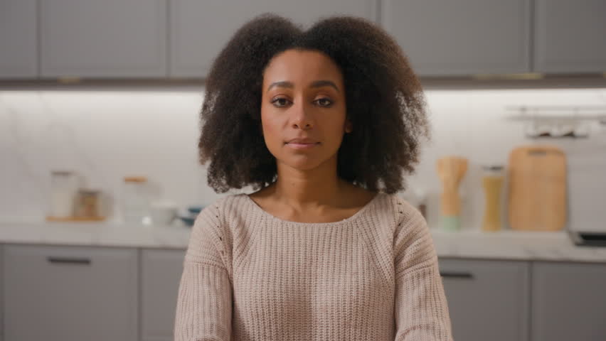 African American ethnic girl confident woman with curly hair lady rent apartment looking at camera in domestic home kitchen posing crossed hands beautiful female housewife mother model portrait indoor Royalty-Free Stock Footage #3446744983