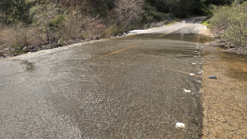 Spring floods in Southern California flood a road.