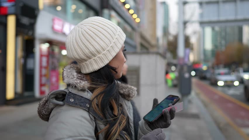 Slow-motion video of a young Filipino woman in her 20s walking in Seoul, South Korea on a cold winter day