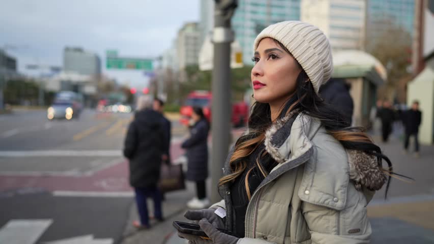 Slow-motion video of a young Filipino woman in her 20s walking in Seoul, South Korea on a cold winter day