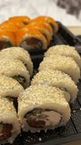 sushi delivery set sushi in plastic containers in real life close-up California rolls with flying fish caviar food delivery to your home