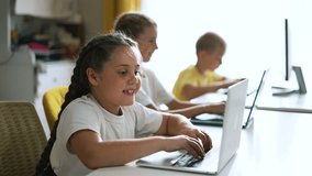 Happy team of friend.Children education at school with laptop.Children play together at computer as team.Online games for teaching teamwork at school in classroom.Online work learning laptop at school - Powered by Shutterstock - Get 15% off with code: PIKWIZARD15