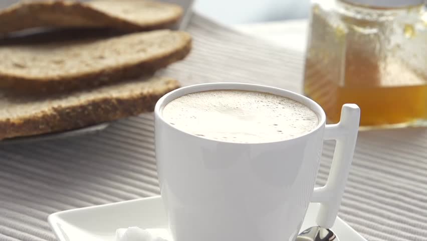 Slowmotion milk drops splash in coffee