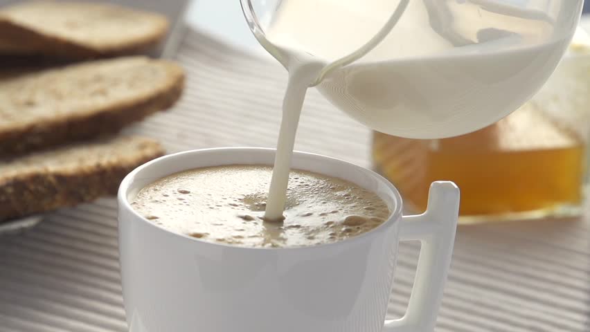 Slow-motion adding milk   in coffee