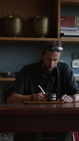 Caucasian digital nomad drinking coffee while working with his tablet