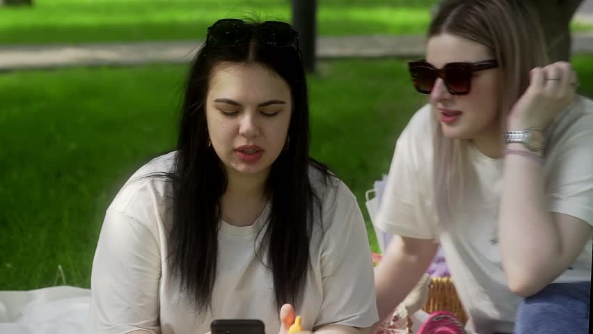 A group of friends on a picnic in nature in the park