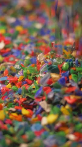 small plastic fragments close up, vertical video. plastic waste, plastic pollution, environment. microplastics, plastic recycling concept