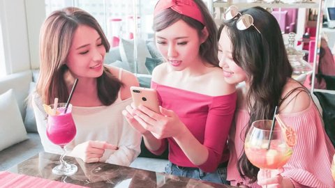 happy woman friends use phone and chatting in restaurant