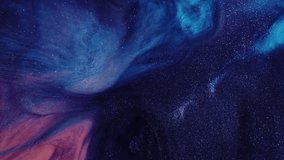An abstract fluid art background displays a mixture of purple and pink colors, reminiscent of a nebula in deep space. This effect is created with glitter and acrylic paints. - Powered by Shutterstock - Get 15% off with code: PIKWIZARD15